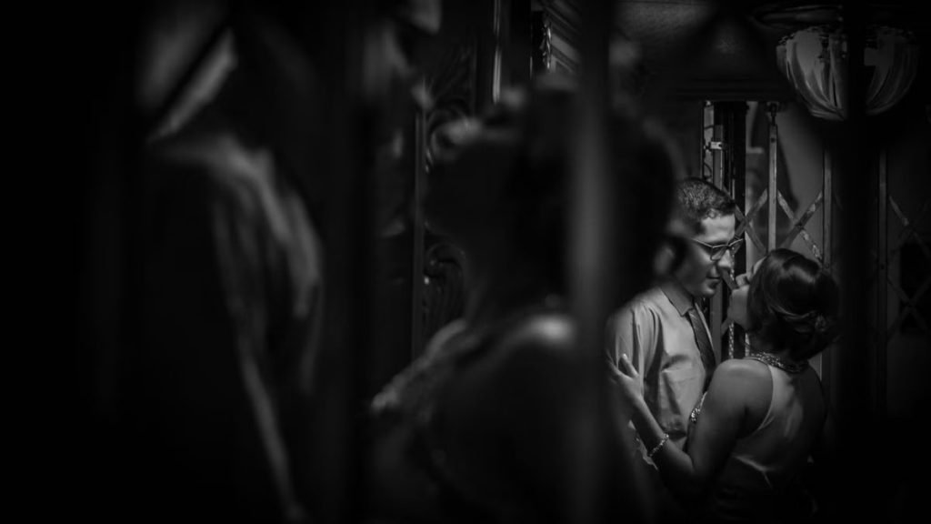 Black and white photo capturing a romantic moment between a couple in an elevator.